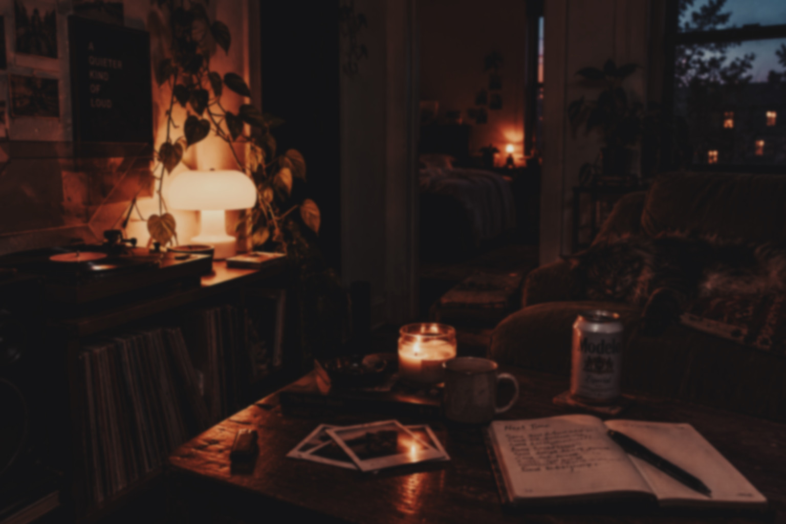 A warmly lit living room with photographs and papers on the table.